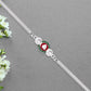 Shiny Silver Rakhi With Ganesha Emblem And Elegant Dual Chain Design