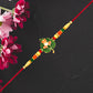 Green Tulsi Leaf Rakhi With Orange Enamel Flower And Beaded Thread