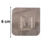 Transparent wall hook attached to smooth indoor surface