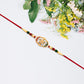 Traditional Oval Rakhi With Kundan Work And Red-green Beads
